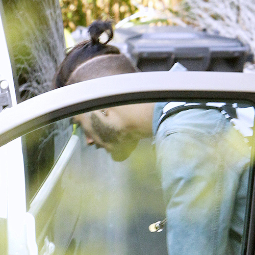 Zayn Malik heads out with cropped hair and pony tail.