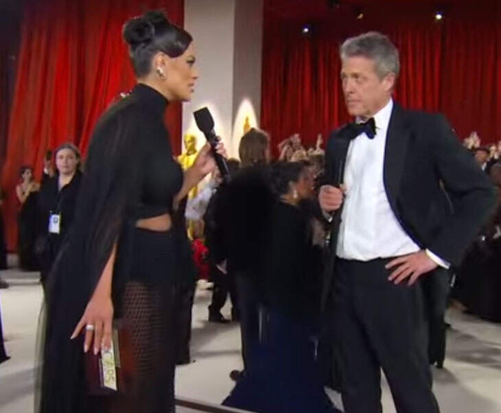 Hugh Grant Brought His Signature Grumpiness To His Oscars Interview With Ashley Graham